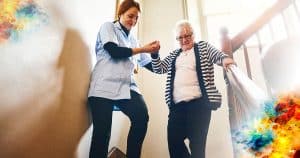 caregiver helping a woman down stairs