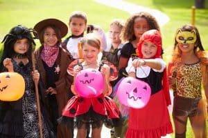 Children In Fancy Costume Dress Going Trick Or Treating Smiling To Camera