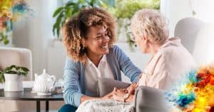 caregiver holding hands of elderly woman in chair